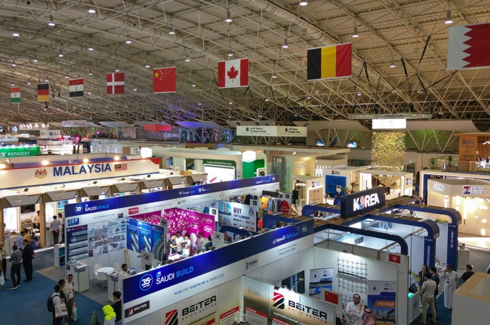 Exhibition hall with national pavilions and country flags at the 35th edition of Saudi Build in Riyadh