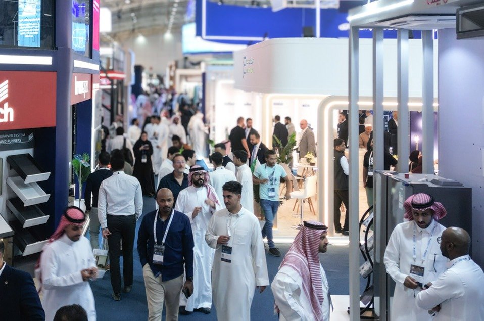 Visitors walking between exhibitor stands at Saudi Build in Riyadh