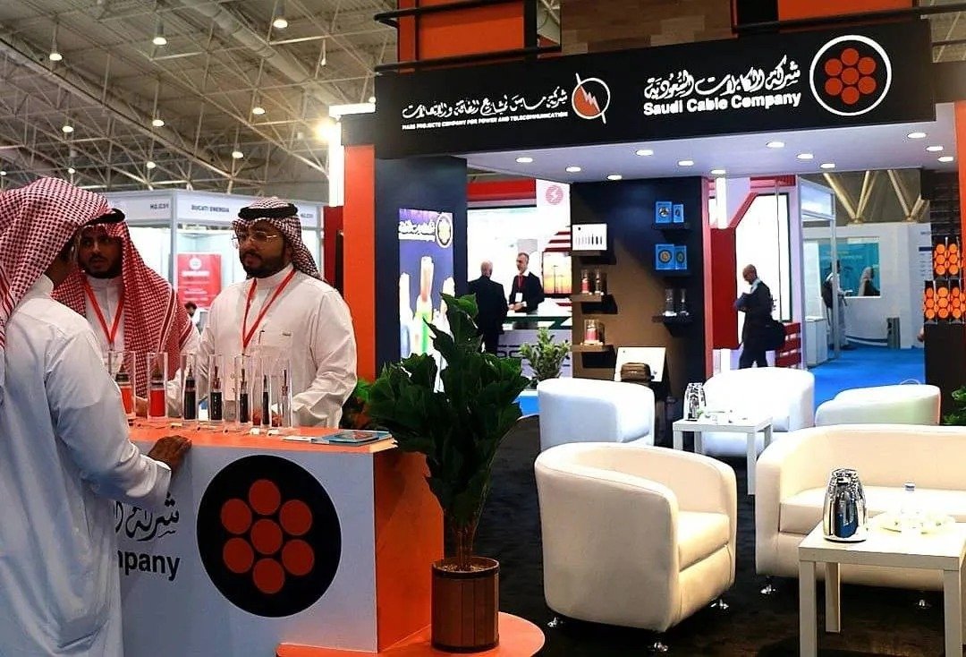 Saudi Cable Company exhibition stand with staff at a trade show