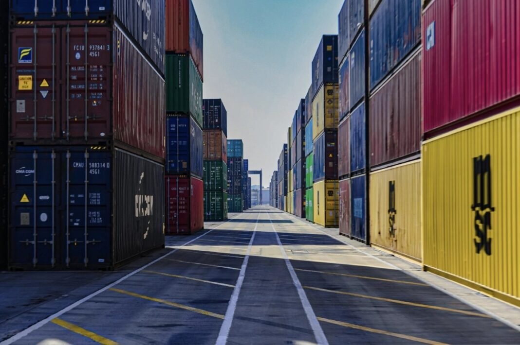 Rows of shipping containers stacked in a port container yard