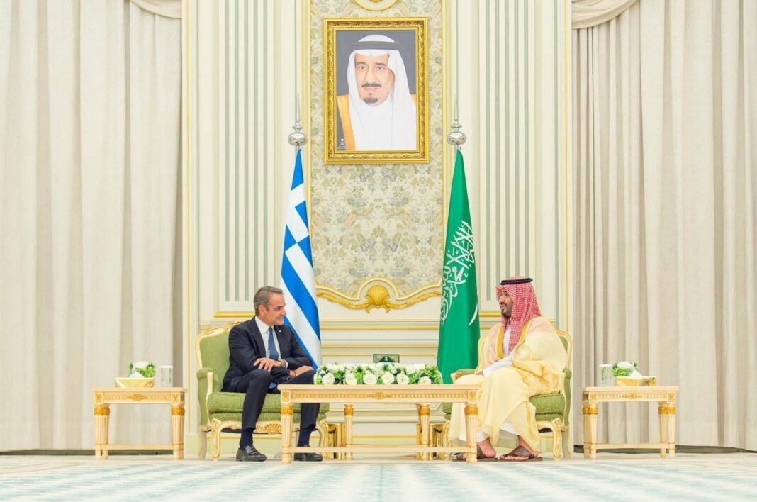 Saudi Crown Prince Mohammed bin Salman and Greek Prime Minister Kyriakos Mitsotakis seated in talks in Riyadh with Saudi and Greek flags