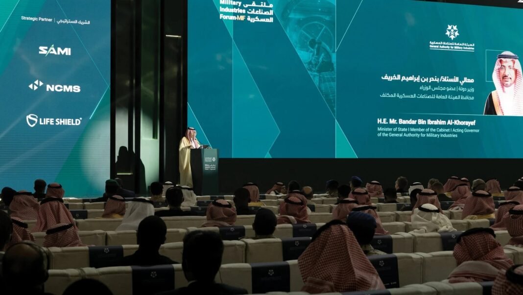 Bandar Alkhorayef speaks from a podium to an audience at the Military Industries Forum in Riyadh