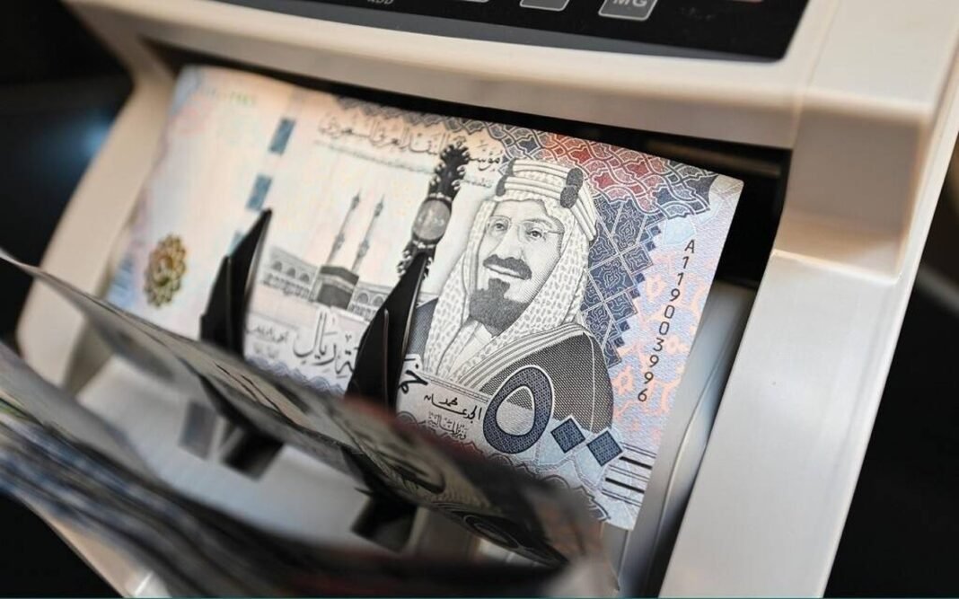 Saudi 500-riyal banknotes passing through a money counting machine