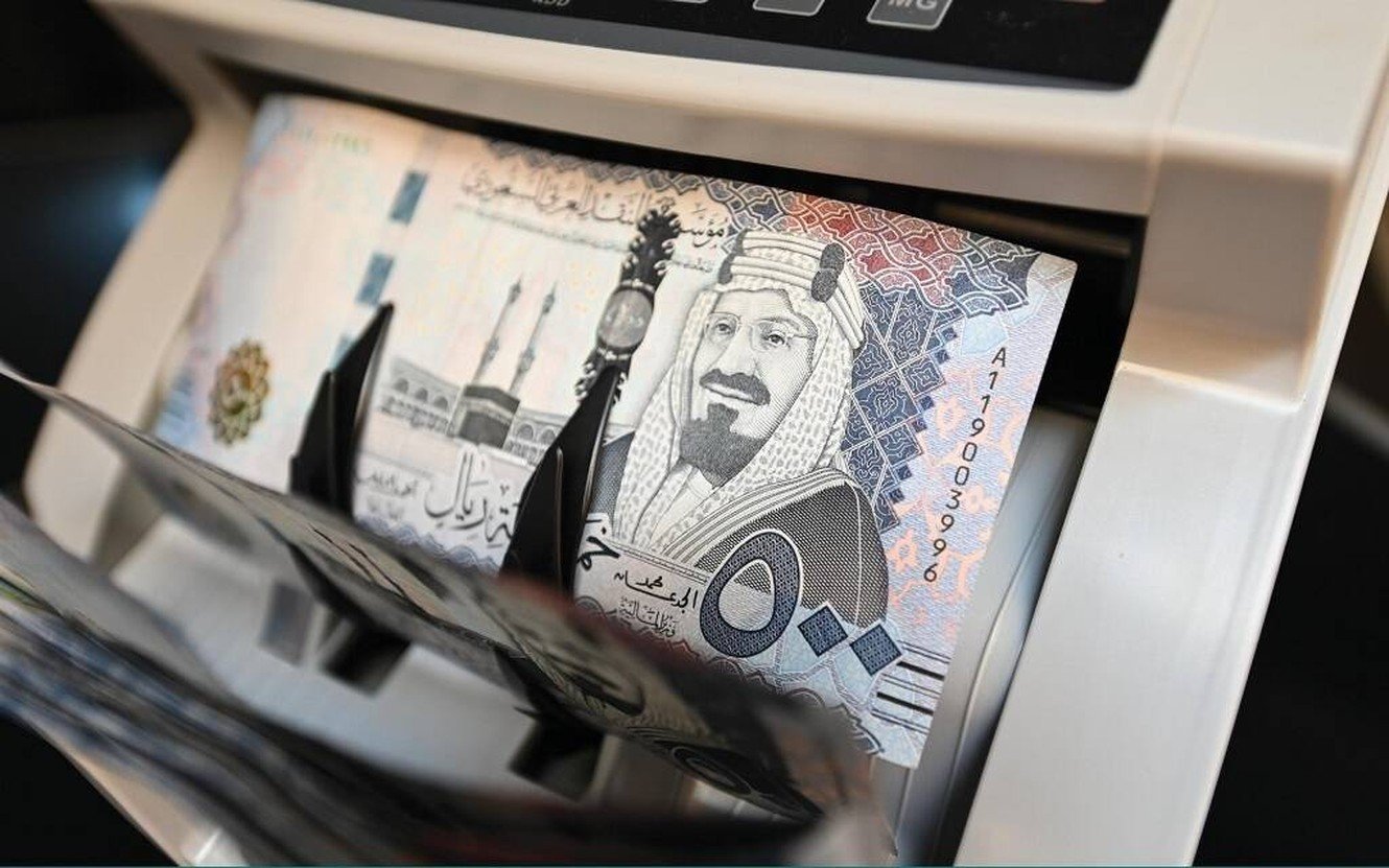 Saudi 500-riyal banknotes passing through a money counting machine