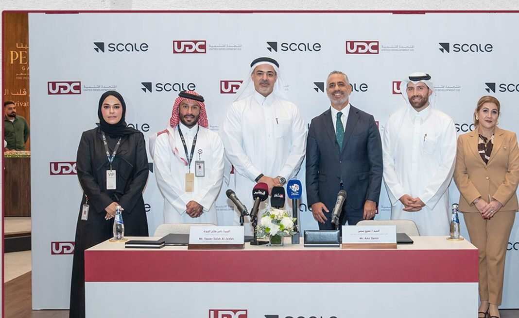 Executives from United Development Company and Scale AI stand behind a signing table in front of a backdrop bearing both company logos at Cityscape Qatar 2026 in Doha