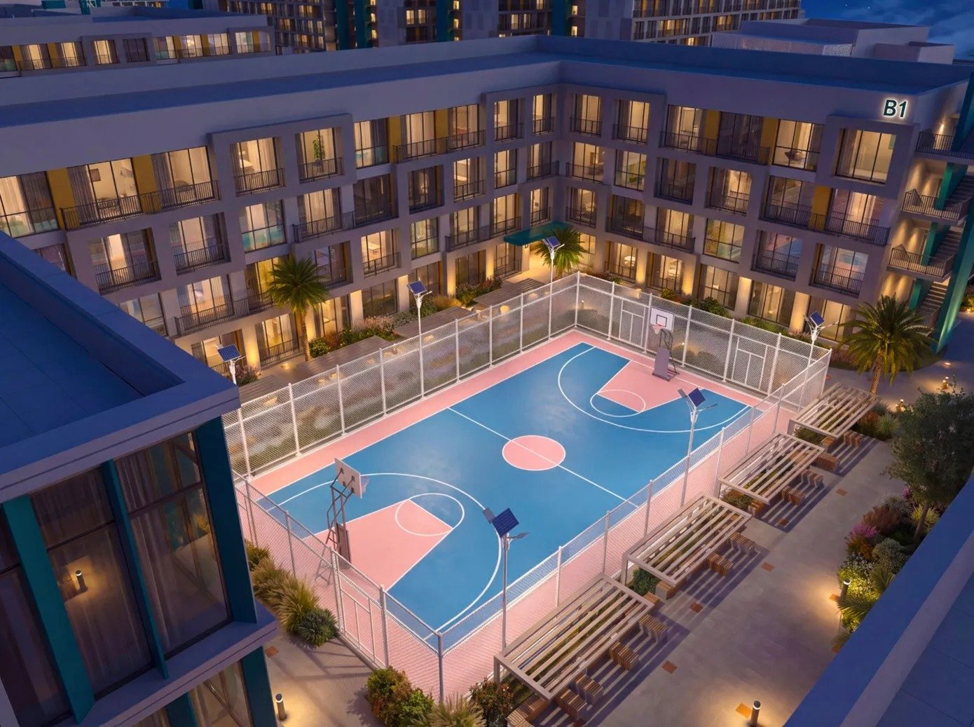 Architectural rendering of residential blocks surrounding an outdoor basketball court at night