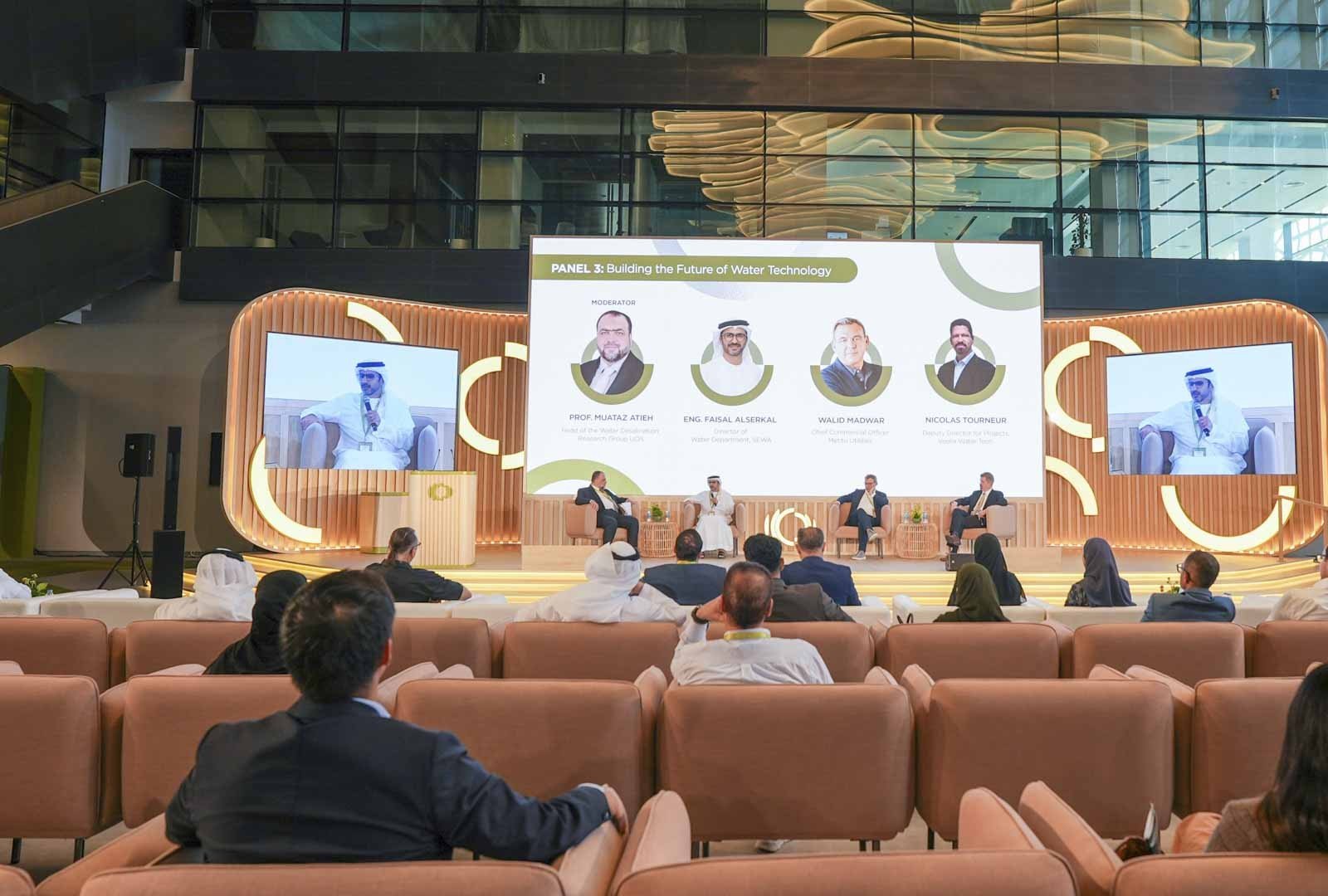 A panel on the future of water technology on stage at the Sharjah: Future Station forum, with an audience seated in front