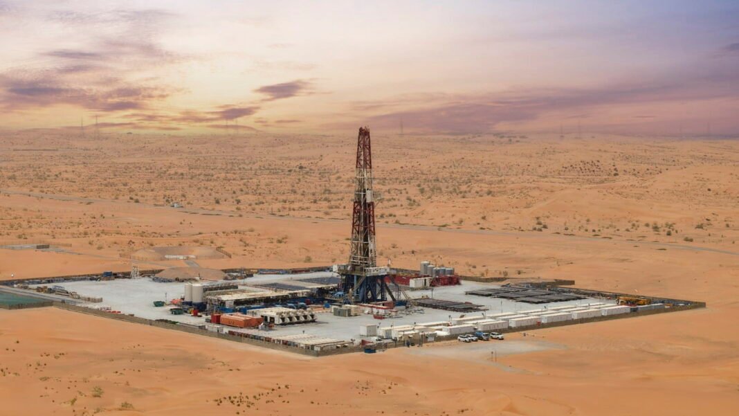 Aerial view of a drilling rig and well site in the Sharjah desert