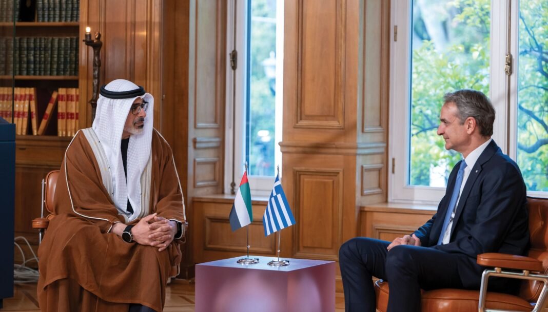 Abu Dhabi Crown Prince Sheikh Khaled bin Mohamed and Greek Prime Minister Kyriakos Mitsotakis seated facing each other with UAE and Greek flags between them