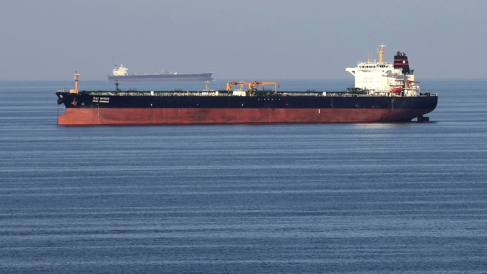 Two oil tankers sailing through the calm waters of the Strait of Hormuz