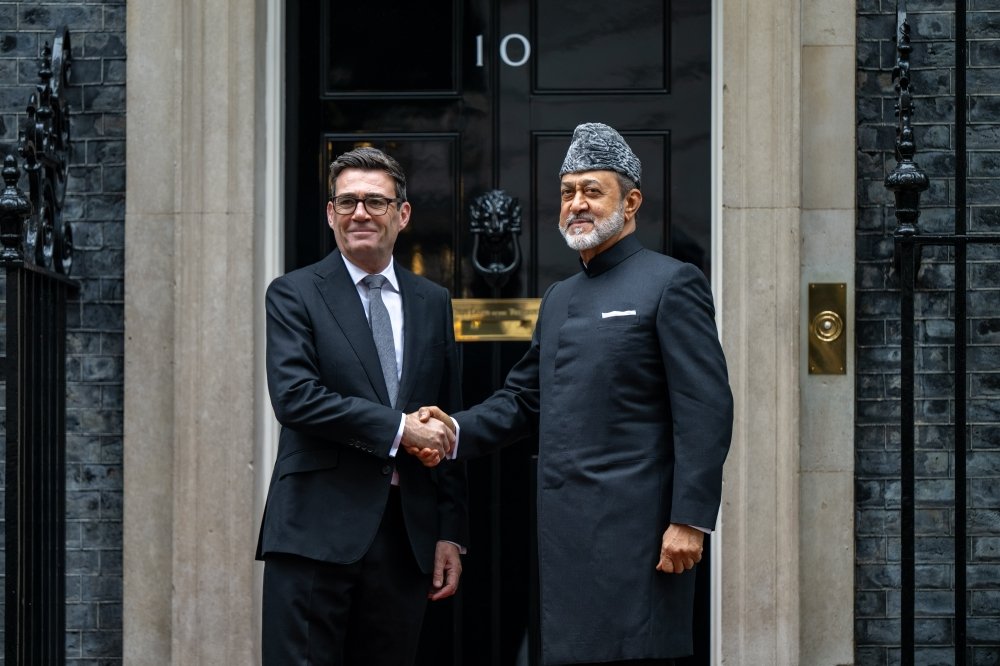 UK Prime Minister Andy Burnham shaking hands with Sultan Haitham bin Tarik of Oman in front of the black door of 10 Downing Street