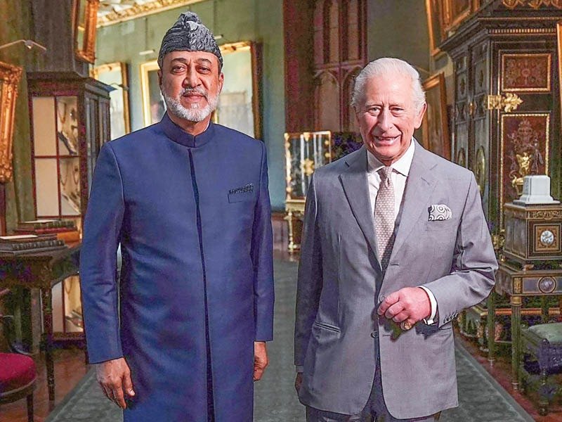 Sultan Haitham bin Tarik of Oman standing beside King Charles III in a palace gallery