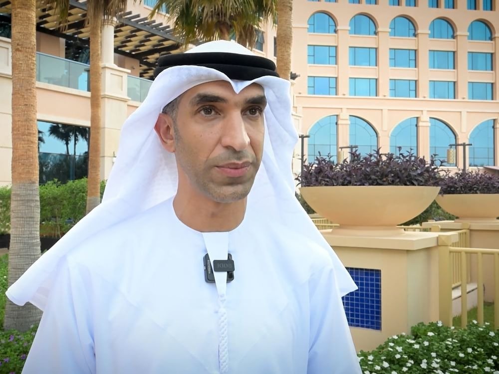 UAE Minister of Foreign Trade Thani bin Ahmed Al Zeyoudi speaks outdoors wearing a clip-on microphone