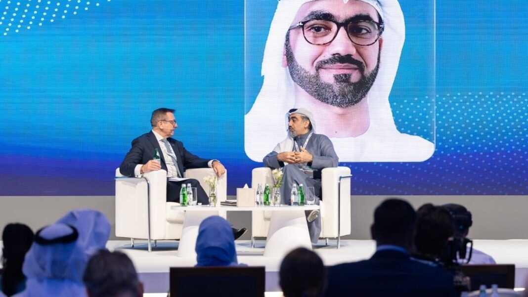 Panel session featuring Waleed Saeed Al Awadhi, chief executive of the UAE Capital Market Authority, with his image on a screen behind the stage