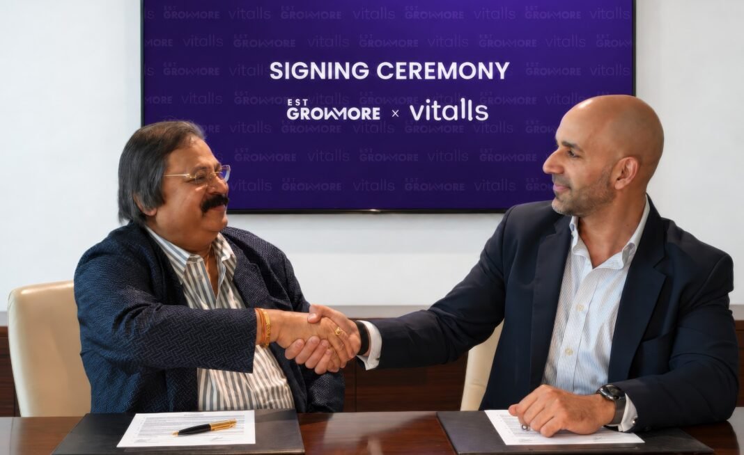 Mehdi Bouchenak of Vitalls and Dr. Sindhu Bhaskar of EST Group shake hands at a signing table