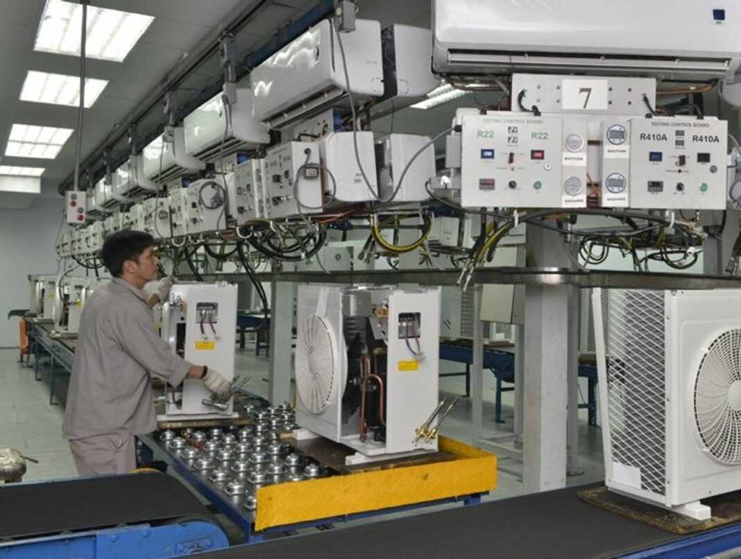 A worker on an air conditioner testing line at a Zamil Industrial factory
